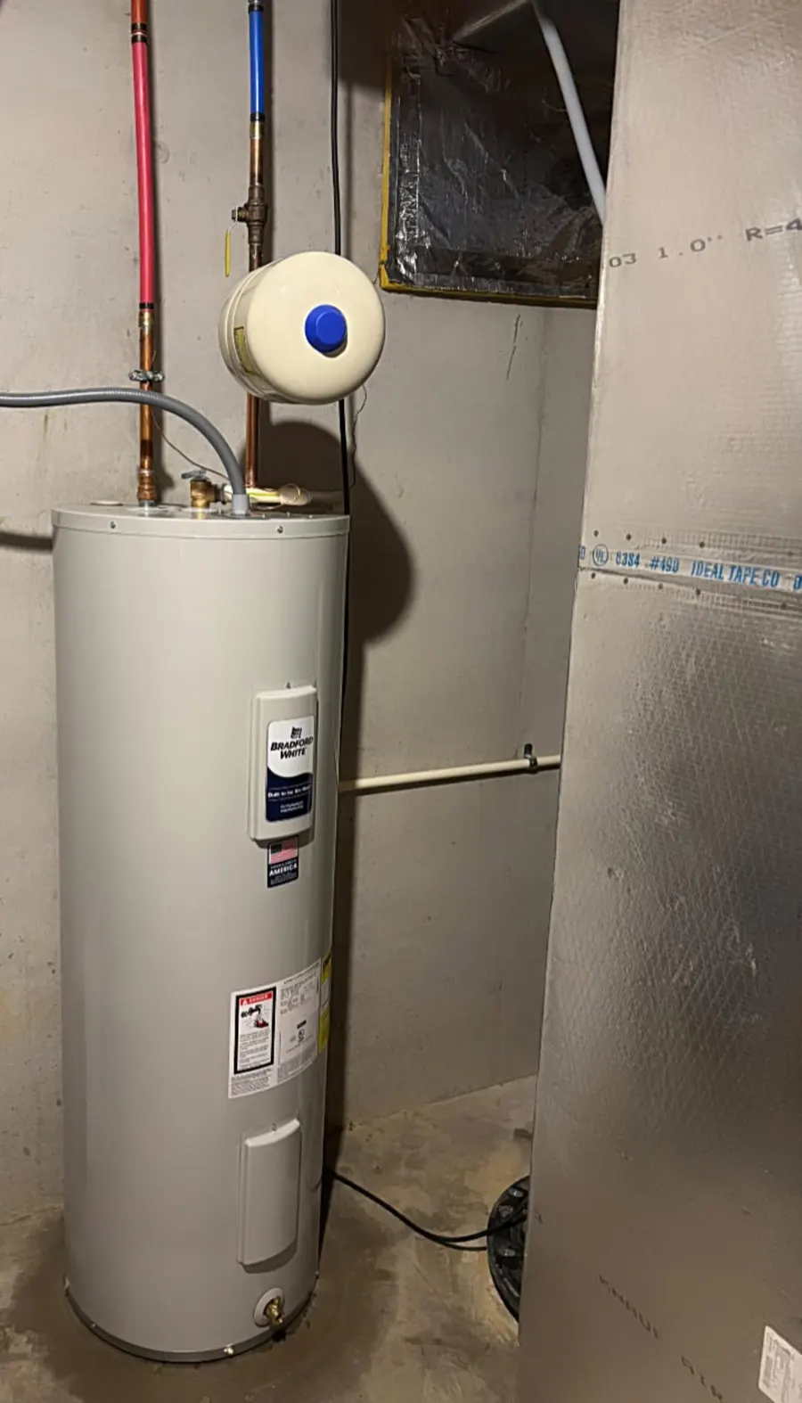 A new electric water heater with an expansion tank, installed by TC’s Plumbing & Service